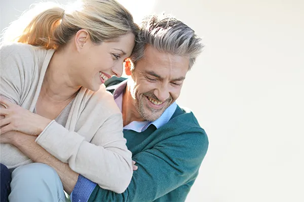 Metformin-Weight-Loss-Clinic A middle-aged couple embrace playfully on a sunny day. Get Metformin for weight loss treatment from Tanya Zboril, NP of TBT Medical in Edmonton