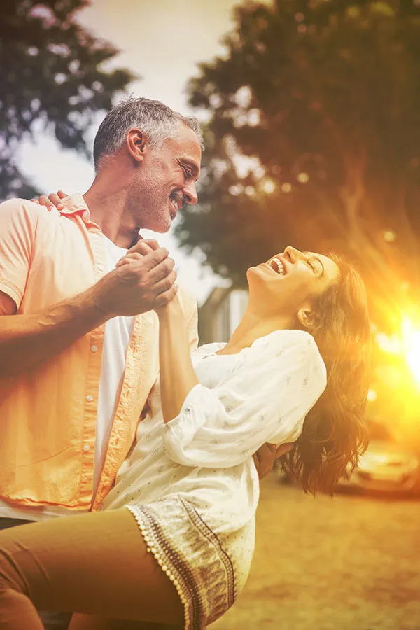 Metformin-Weight-Loss-Treatment A middle-aged couple dances playfully in the woods at sunset. Get Metformin for weight loss treatment from Tanya Zboril, NP of TBT Medical in Edmonton