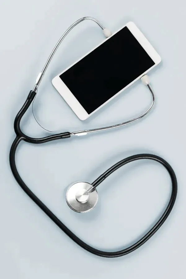 Telemedicine-Treatment A smartphone with a stethoscope attached to it, symbolizing Telemedicine treatment from Tanya Zboril, NP of TBT Medical in Edmonton.